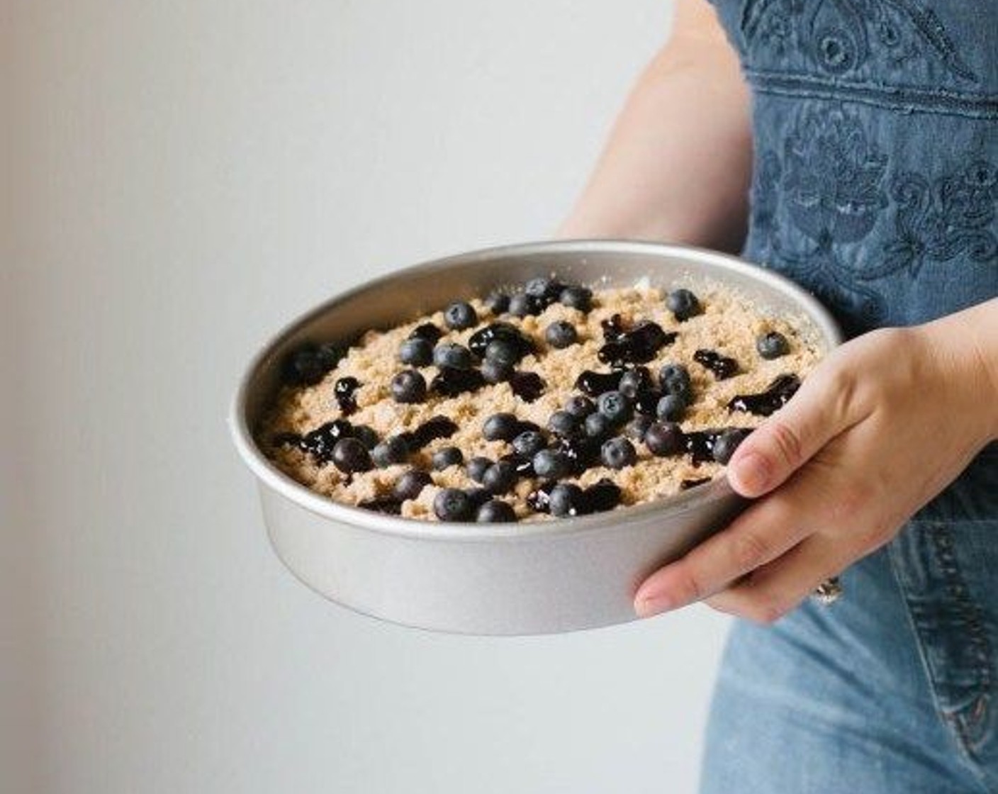 step 7 Sprinkle crumble on top of the cake along with the Fresh Blueberry (1/3 cup) and dot with the Blueberry Jam (2 Tbsp). Bake in the oven for 45-50 minutes or until a toothpick inserted in the center comes out clean.