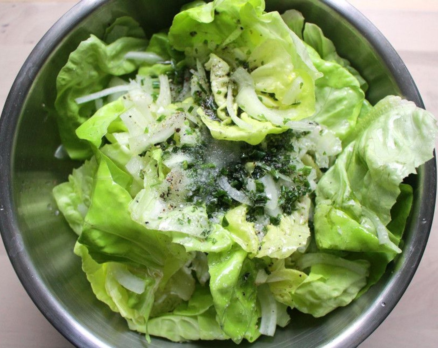 step 5 In a separate bowl, pour the dressing over the Butter Lettuce (1 head) and toss together. Set aside.