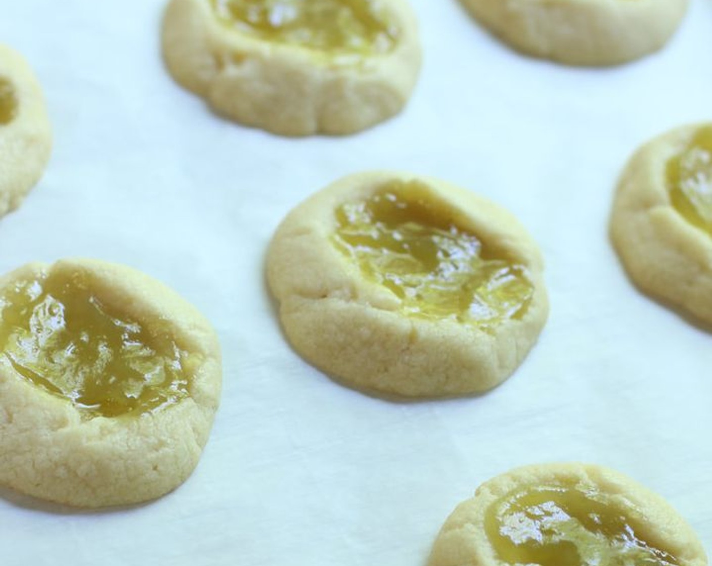 step 10 Remove from oven and immediately spoon an additional 1/2 teaspoon of Key Lime Curd (1/2 cup) into each cookie, smoothing it around to fill the indentation evenly. Allow the cookies to cool on the baking sheet. Cool to room temperature before glazing.