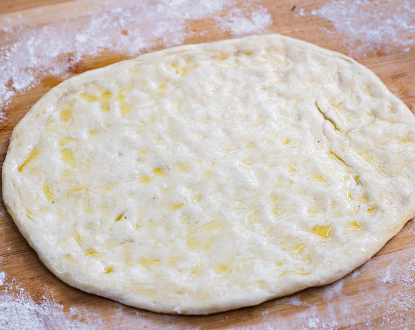 step 3 Brush half of Extra-Virgin Olive Oil (2 Tbsp) onto top of crust.