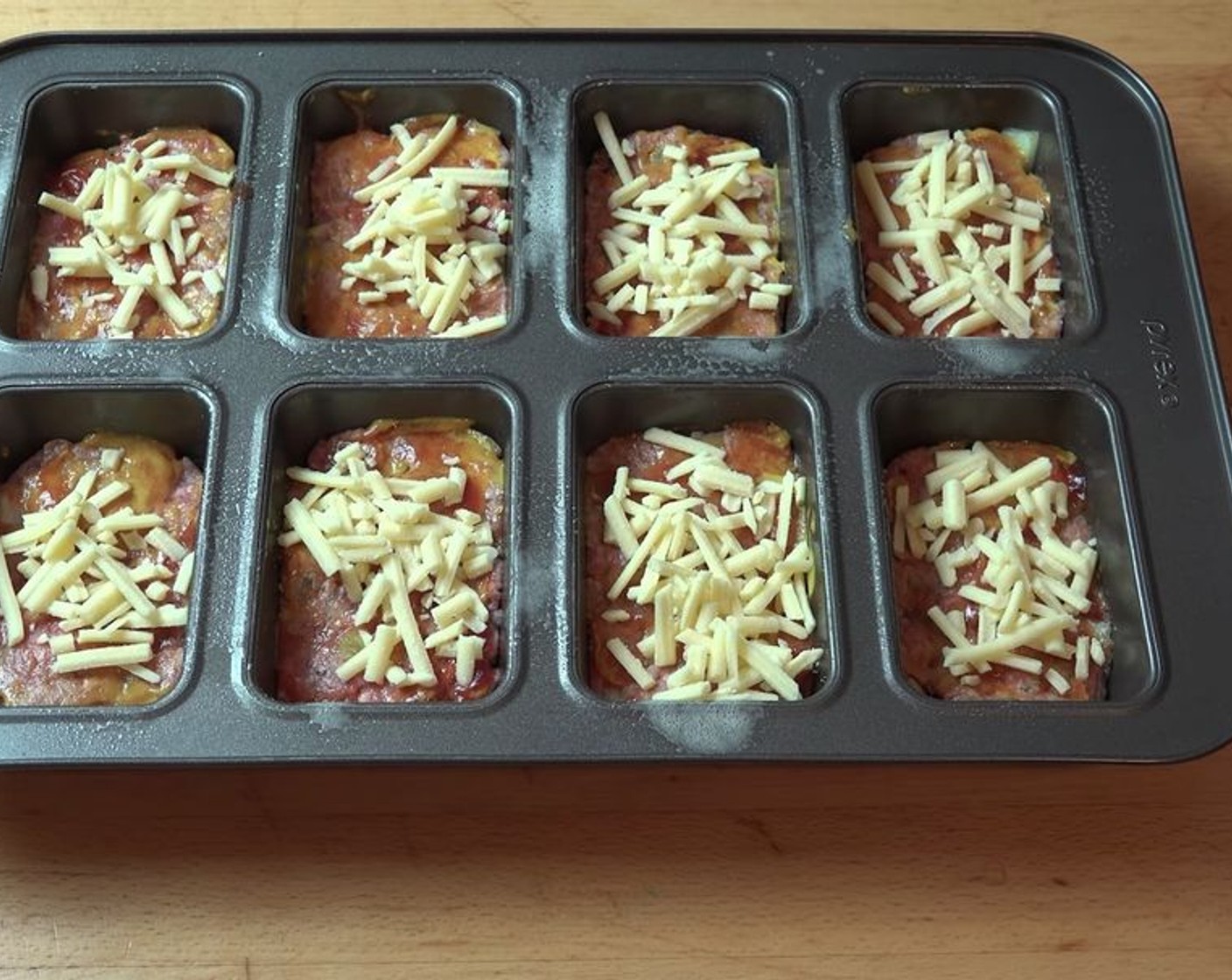 step 6 Top each mini meatloaf with Cheddar Cheese (to taste).