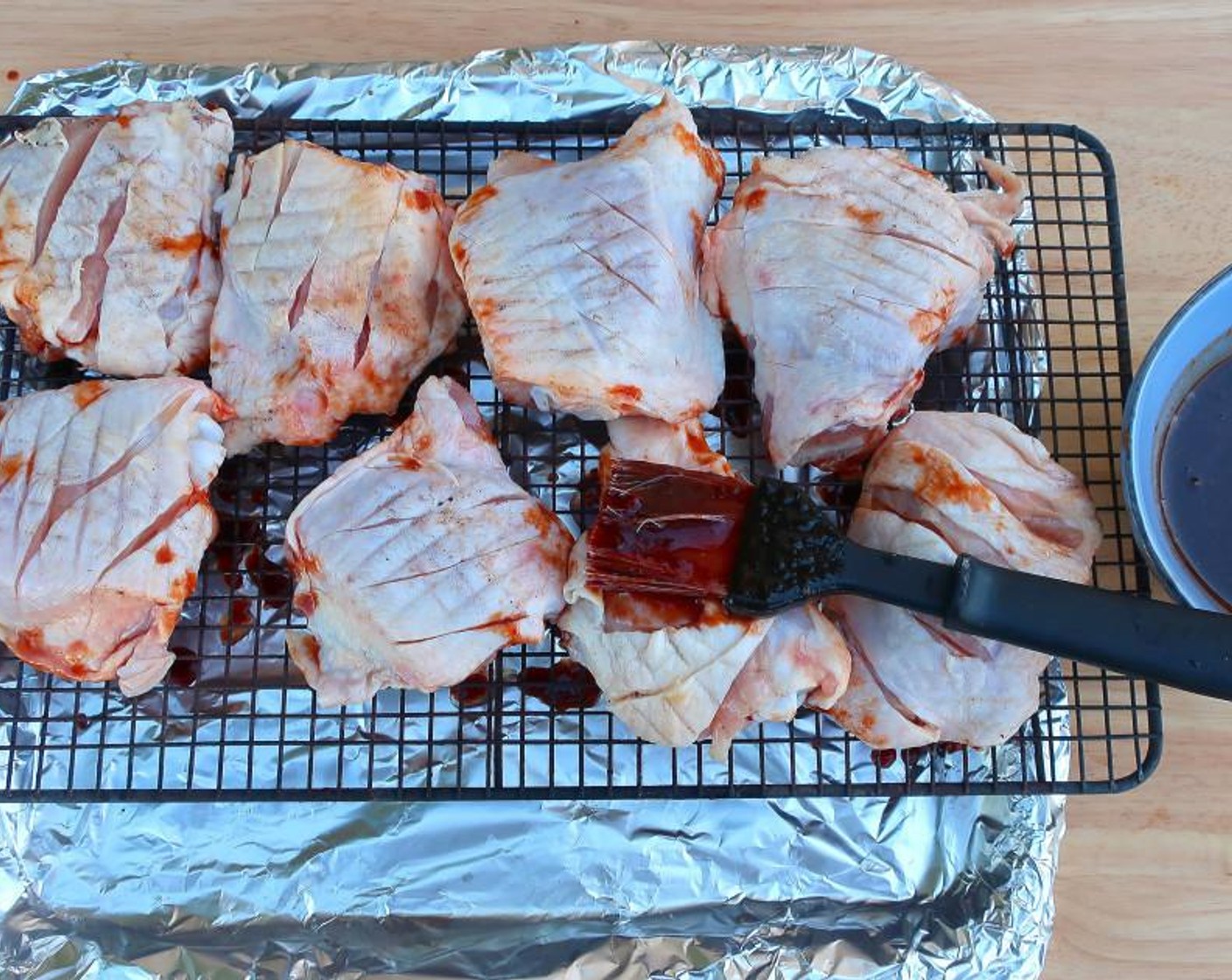 step 1 Mix Hoisin Sauce (1 cup), Honey (1 Tbsp), Thai Sweet Chili Sauce (1 Tbsp), Soy Sauce (1 cup), and Garlic Paste (1 tsp). Incise Chicken Thighs (8) with 4 cuts on each side, brush with the marinade, place on a wire rack over a baking pan with 1/2 qt water added, and roast at 375 degrees F (190 degrees C) until meat is halfway cooked.