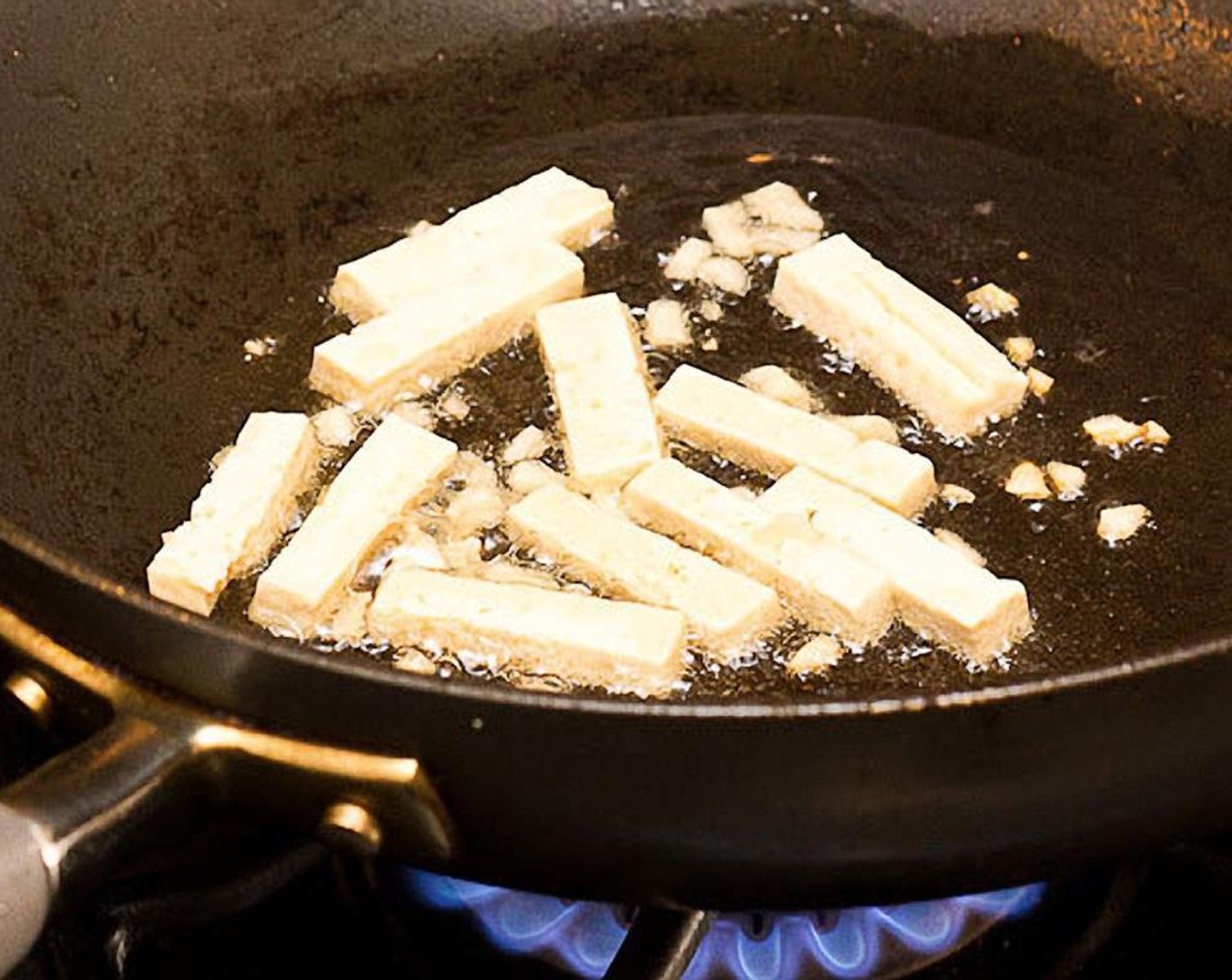 step 8 Add firm tofu and garlic. Cook for about 45 secs, stirring frequently. Garlic should now be brown.