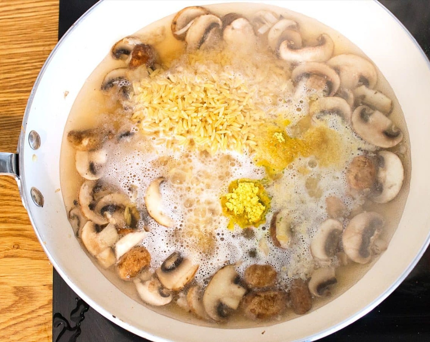 step 3 Once the mushrooms have softened slightly and are starting to brown in color add the boiling Water (1 2/3 cups) and Orzo Pasta (1 cup) to the pan. Season it with Salt (1/2 tsp), Nutritional Yeast (1 Tbsp), and Vegetable Broth Powder (1 tsp).