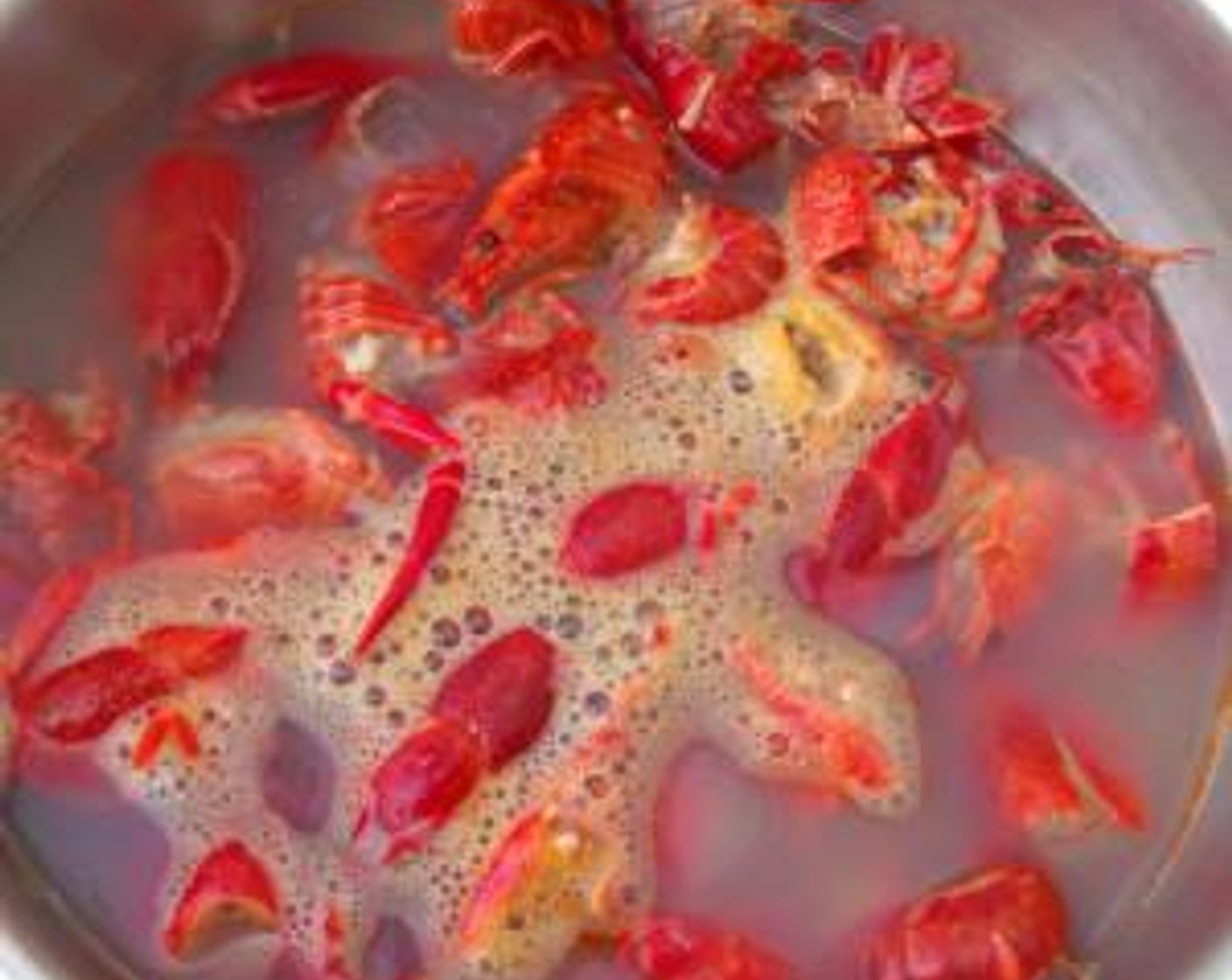 step 2 Simmer the shells and legs in Water (4 cups), 1/2 tsp Garlic Paste (1 tsp) and Sweet Chili Paste (1 tsp) until reduced to 1/2 cup.