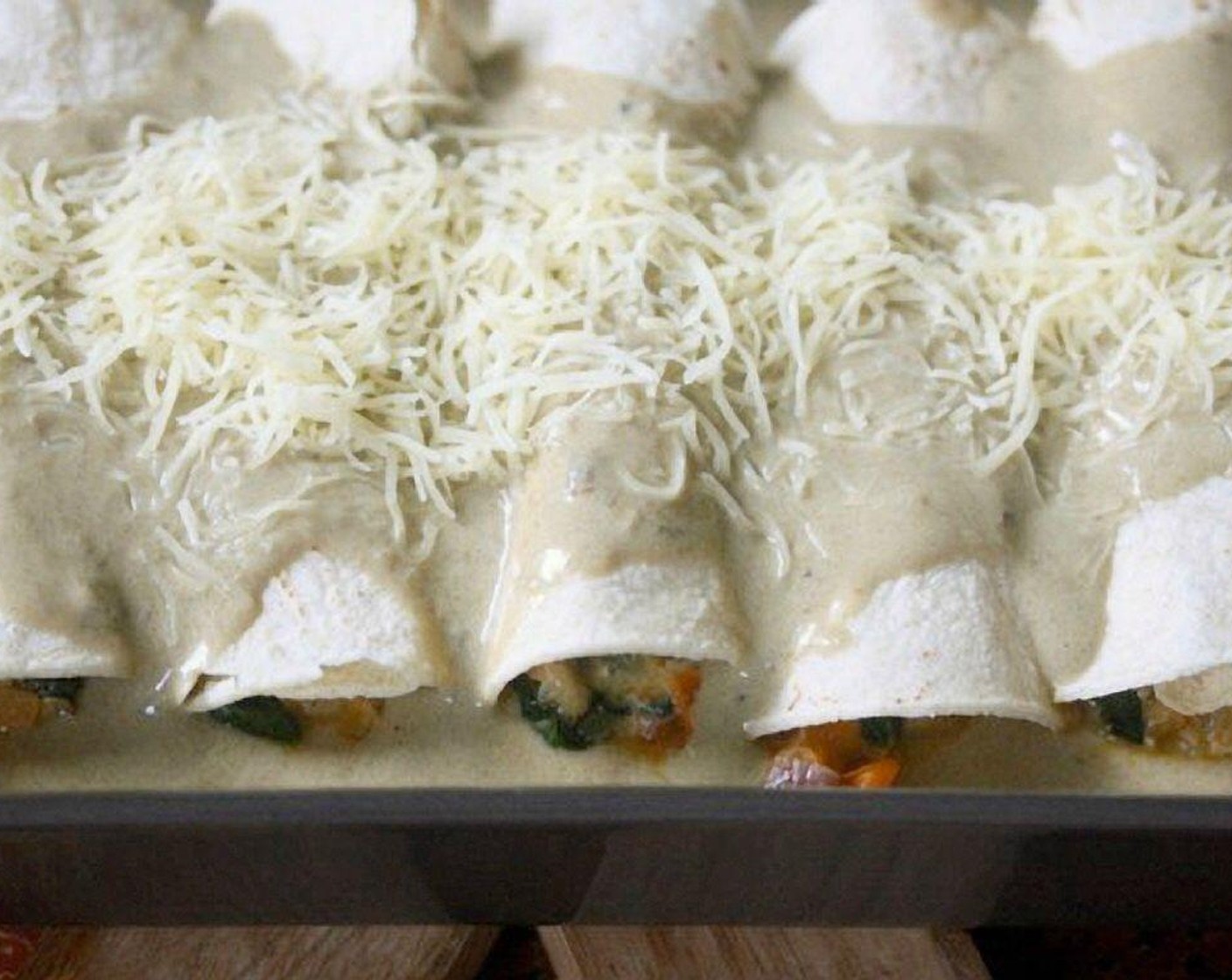 step 8 Pour the remaining sauce over the enchiladas and sprinkle with the remaining Monterey Jack Cheese (3/4 cup).