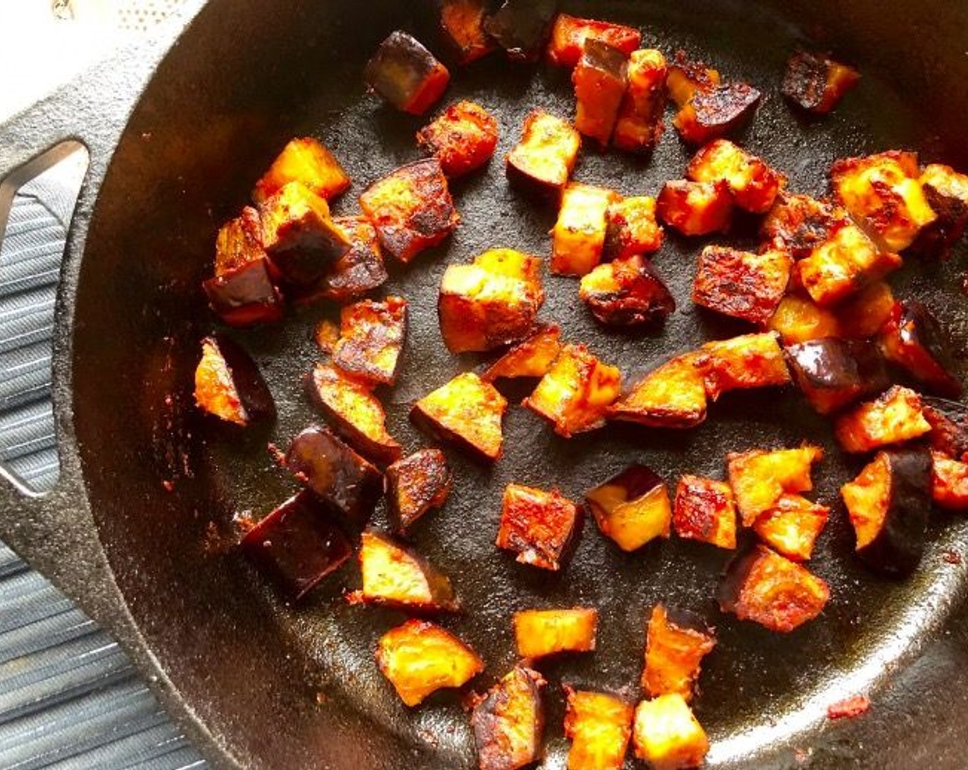 step 4 Heat a heavy-based frying pan or cast iron skillet over medium heat. Working in 3 batches, add the eggplant cubes to the pan and cook for 4-5 minutes until tender and golden, tossing frequently to brown all sides. You may need to drizzle additional Extra-Virgin Olive Oil (1 Tbsp) as you proceed to prevent sticking. Transfer to a baking sheet or platter. Set aside.