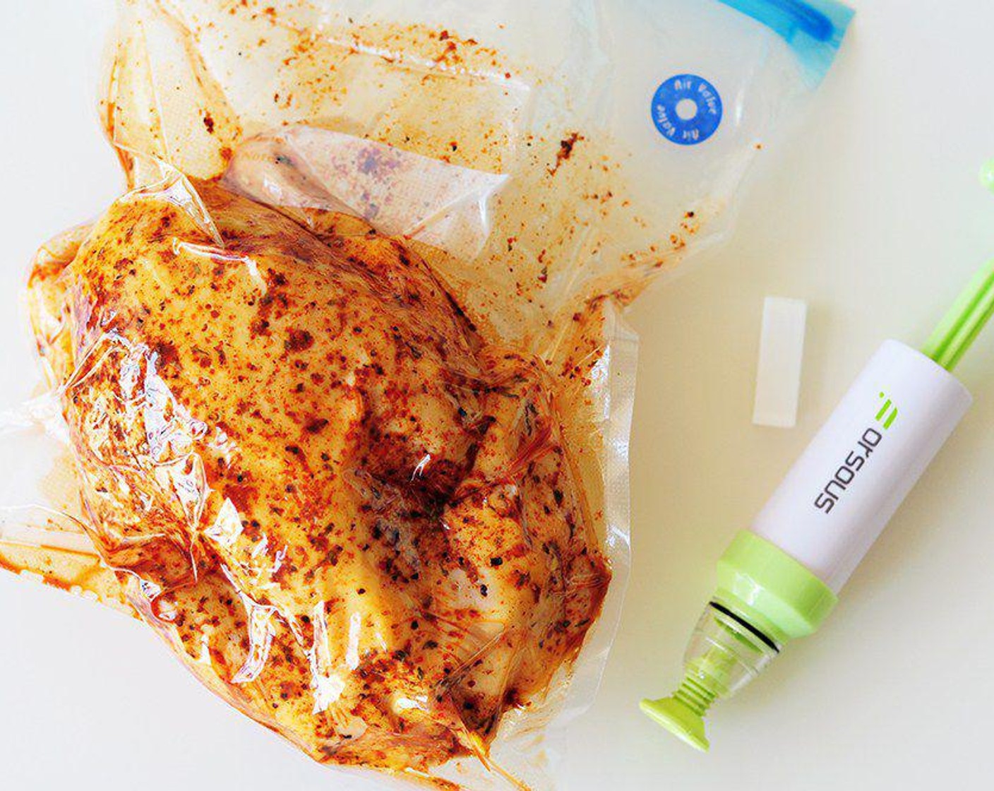 step 4 Slide the chicken into the prepared bag. Unfold the edge before closing the bag. Seal the bag using either a vacuum sealer or a hand pump.