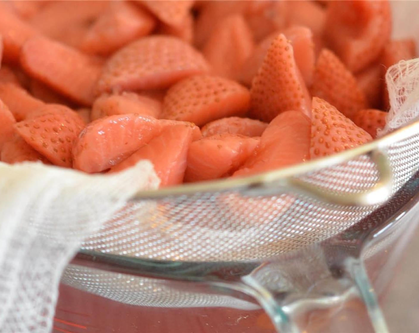 step 5 After three days, line a mesh strainer with cheese cloth and place over a large container that will hold about 3 to 4 cups of liquid. Pour strawberries and vodka into strainer. Let sit and strain for several minutes. Discard strawberries.