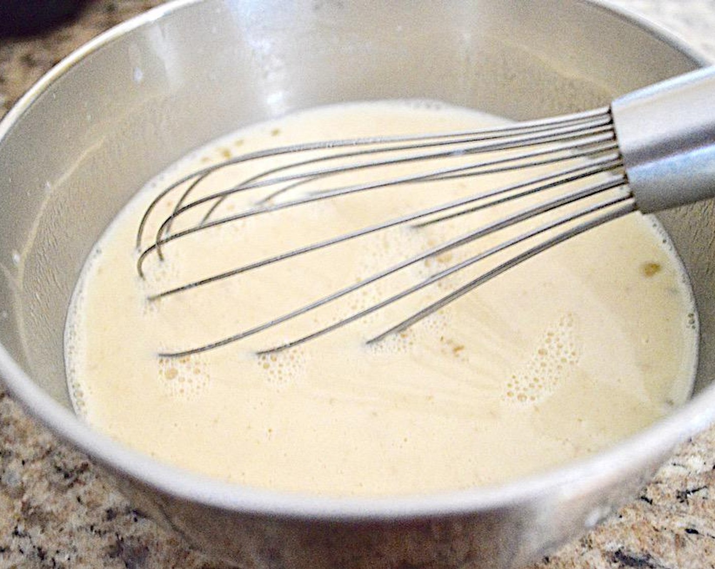 step 5 When the milk is gently bubbling, slowly whisk it into the eggs. Do just a little at first so that the eggs do not scramble. Once you have whisked in all of the milk, whisk in the  Vanilla Extract (1 Tbsp). Then the custard is done and it is time to assemble everything.