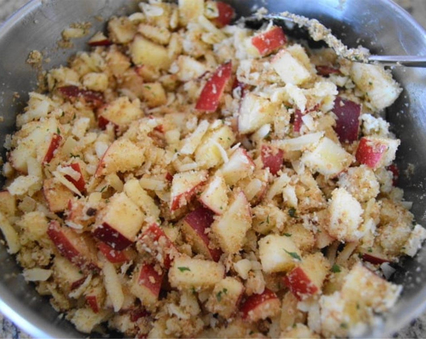 step 4 In the meantime, make the filling. In a bowl combine Apples (2), Gruyère Cheese (1 1/2 cups), Seasoned Breadcrumbs (1/2 cup), Apple Sauce (1 Tbsp), Ground Cinnamon (1/2 tsp), Truffle Sea Salt (1 pinch), and Butter (2 Tbsp). Stir it together thoroughly to make the filling.