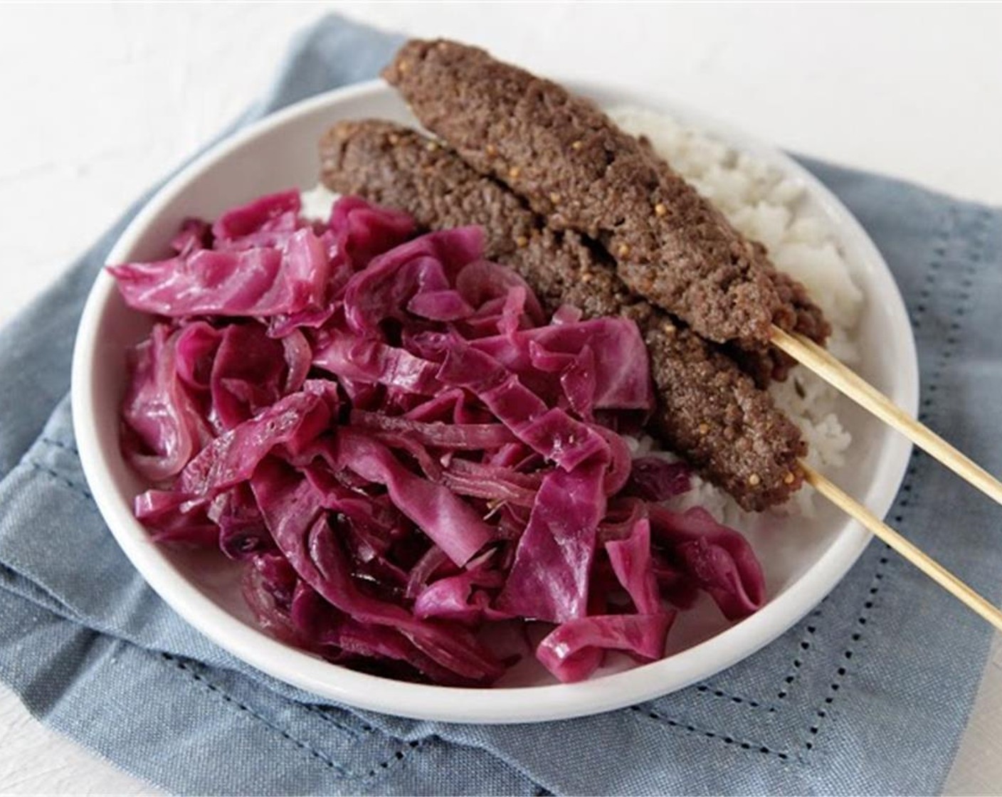 step 6 While rice is cooking, heat a large sauté pan over medium-high heat. Brown the kebabs on all sides to cook through. Remove kebabs from the pan, reduce heat to medium, then add Cooking Oil (1 Tbsp) and sliced onion.