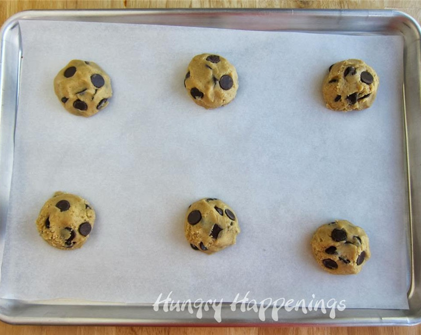 step 5 Fold 3/4 of the Semi-Sweet Chocolate Chips (1 1/2 cups) into the batter. Scoop out 18 cookies, about 1/4 cup of dough for each. Place cookies on a parchment paper-lined baking sheet with plenty of room to spread.