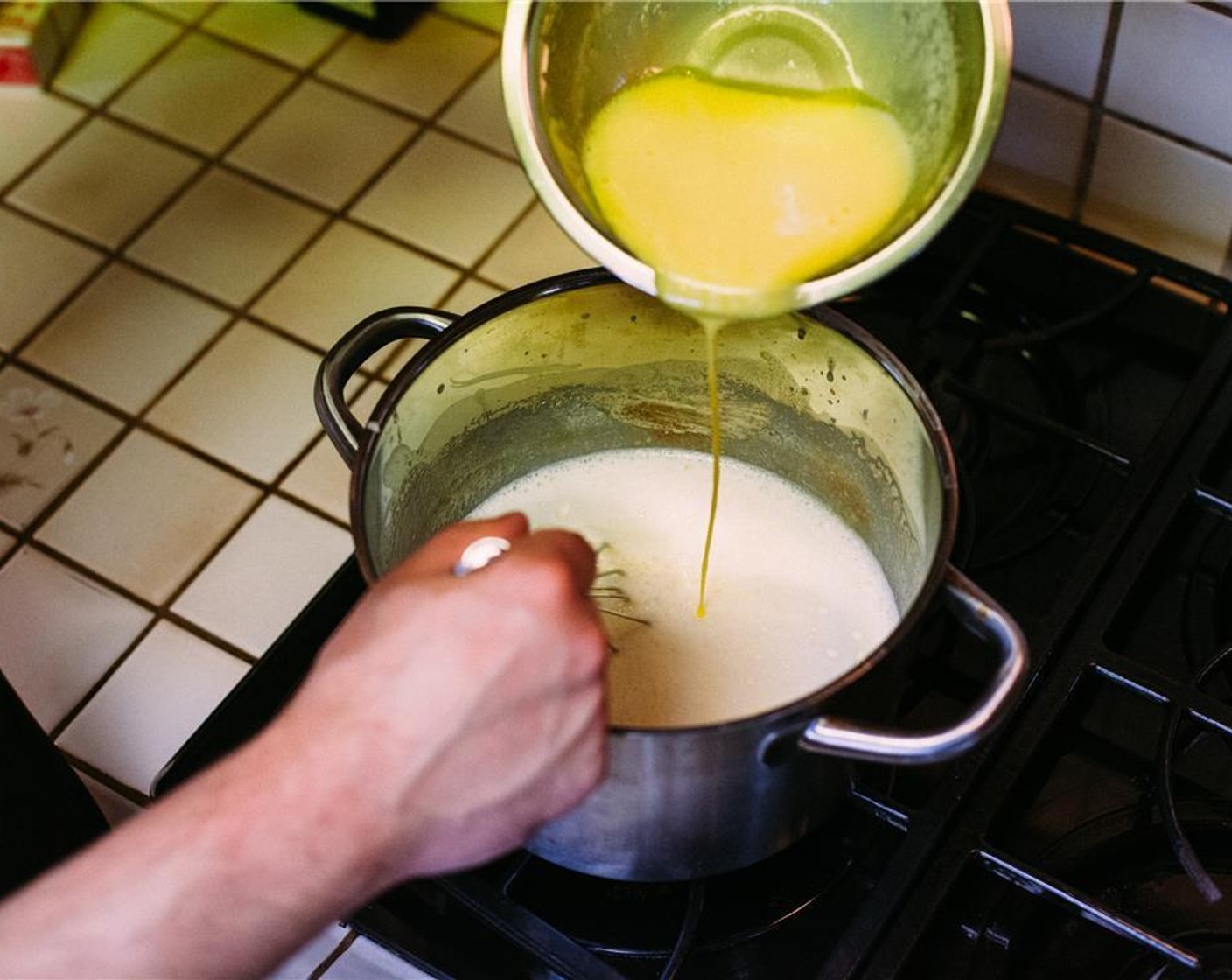 step 4 Return pan to stovetop over low heat. Whisking constantly, stream yolk-cream mixture back into pan.