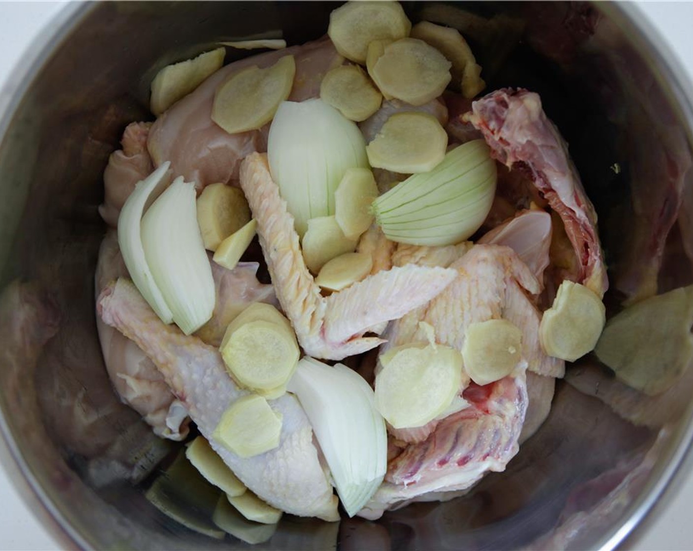 step 2 Peel and slice the Fresh Ginger (2 in) and add to pot. Add the Sea Salt (1/2 Tbsp) and filtered Water (8 1/3 cups), ensure it just covers the chicken. If the chicken is whole, you may need to add more water. Bring to a boil uncovered, then reduce to simmer for 20 minutes.