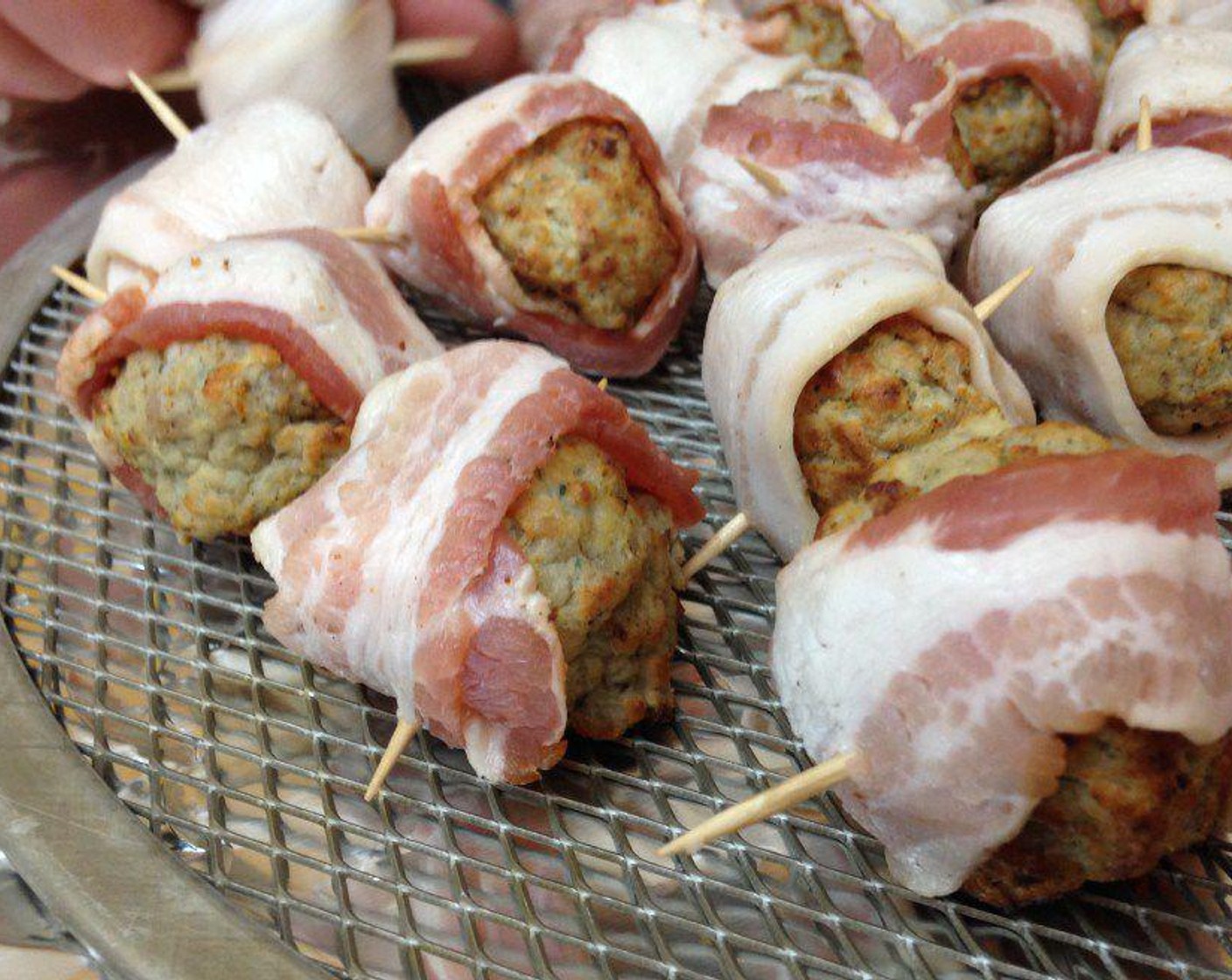 step 1 Take your Bacon (12 slices) and cut the slices in half. To assemble your moink balls, wrap the bacon around the Meatballs (4 1/2 cups) and use a toothpick to hold the bacon in place.