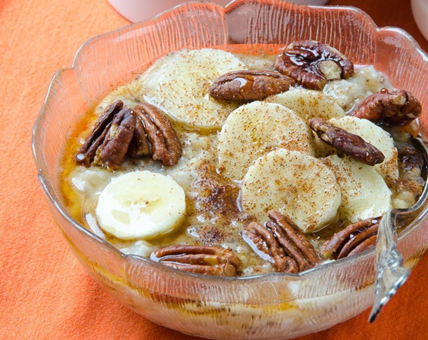 step 7 For banana maple pecan topping:  Swirl Banana (1/4 cup) into the oatmeal. Top with Bananas (5 slices), Ground Cinnamon (1 dash), Ground Nutmeg (1 dash), Roasted Pecans (to taste) and Maple Syrup (1 Tbsp).