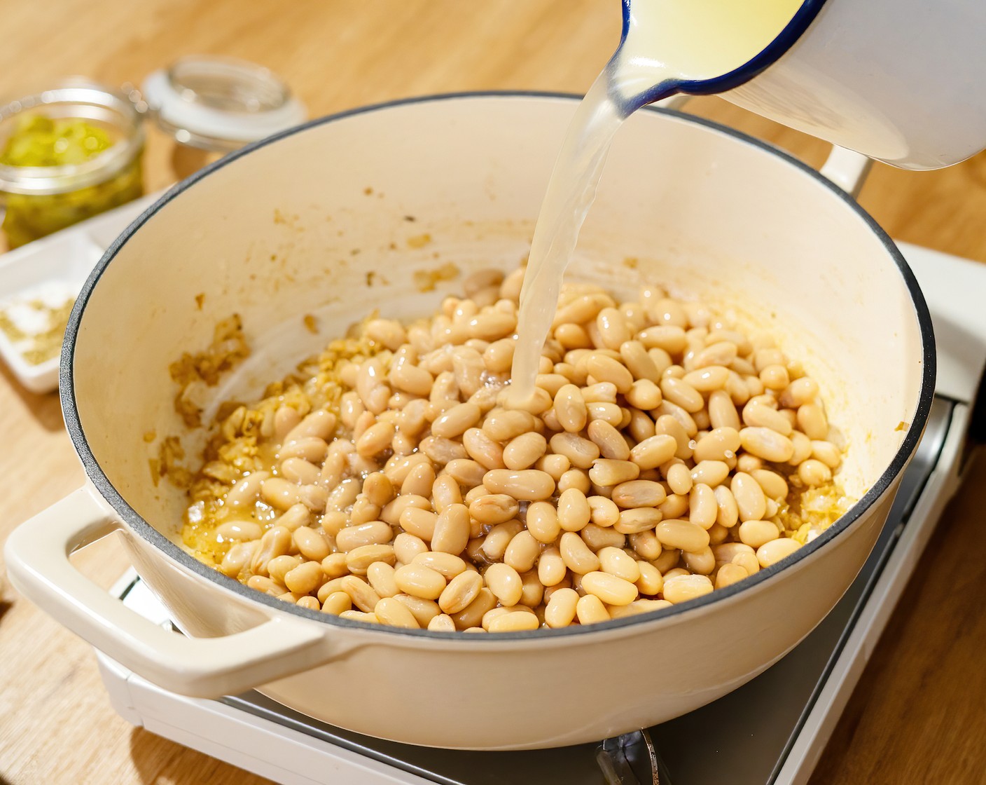 step 2 Add the Cannellini White Kidney Beans (2 cans), Mild Diced Green Chiles (2 cans), and Chicken Broth (2 cups). Cook for 15 minutes.