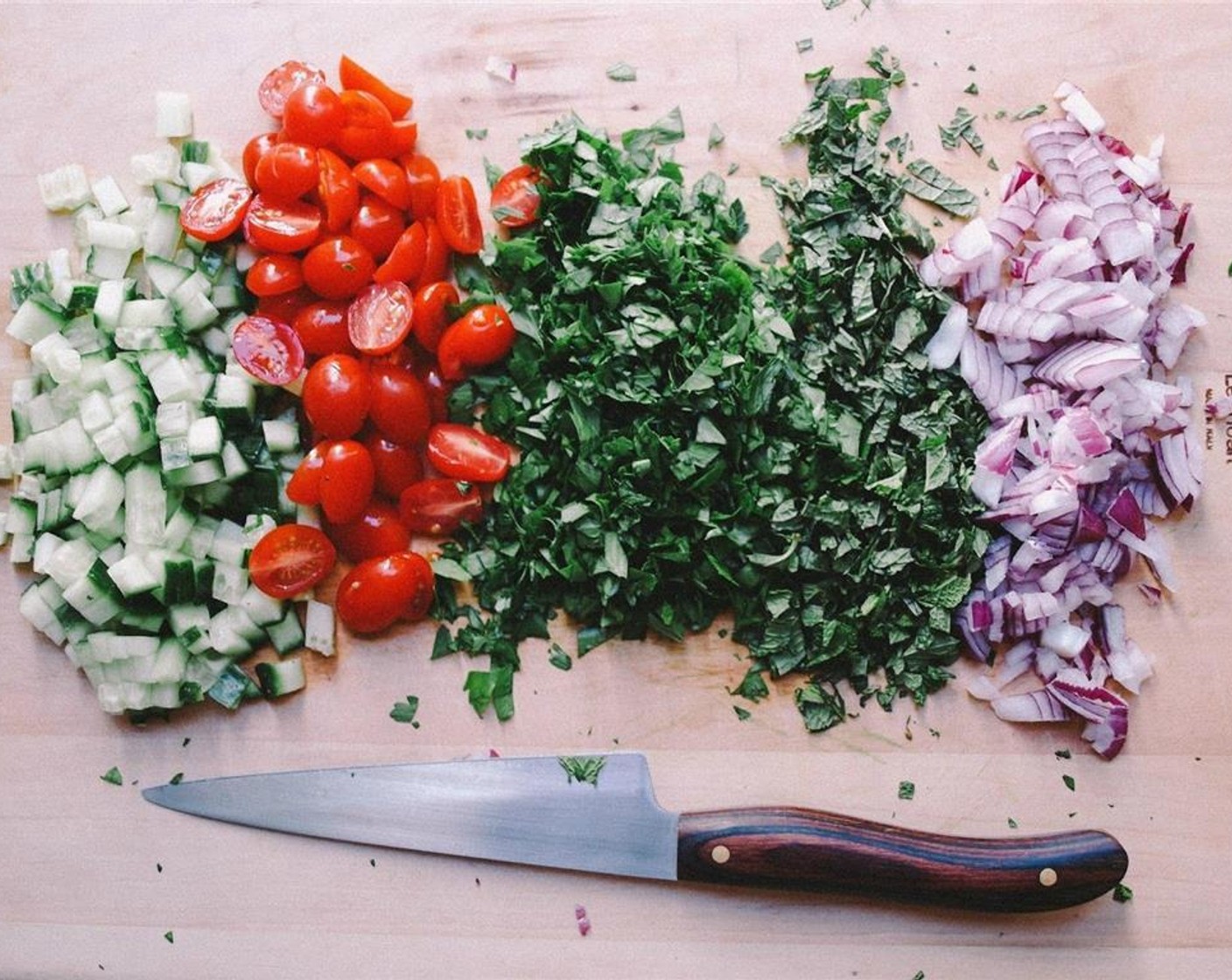 step 3 In the meantime, finely chop your Fresh Parsley (2 cups) and Fresh Mint Leaves (1 cup). Dice your English Cucumber (1), Red Onion (1) and halve the Grape Tomatoes (1 1/2 cups).