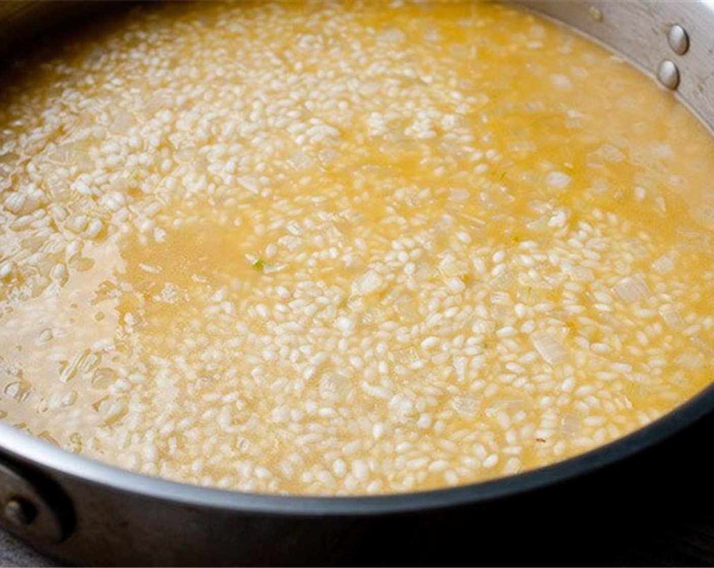 step 5 Slowly add Vegetable Stock (8 cups) to the risotto and stir it as the rice absorbs the stock. Add about 3/4 cup stock at a time and stir it into the rice.