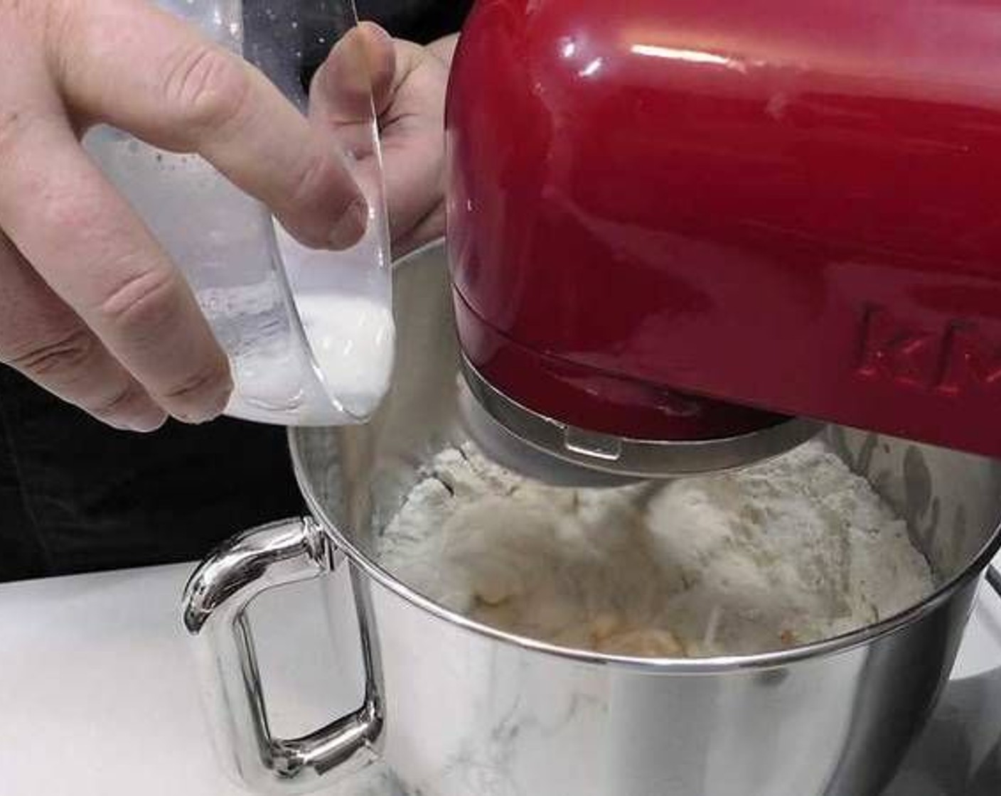 step 3 In a stand mixer add the All-Purpose Flour (4 3/4 cups) and make a small hole in the center. Add the Egg (1), Oranges (to taste), Butter (1/4 cup), Granulated Sugar (1/2 cup), a pinch of salt, and mix. Next, slowly add the milk mixture into the mixing bowl as it mixes.