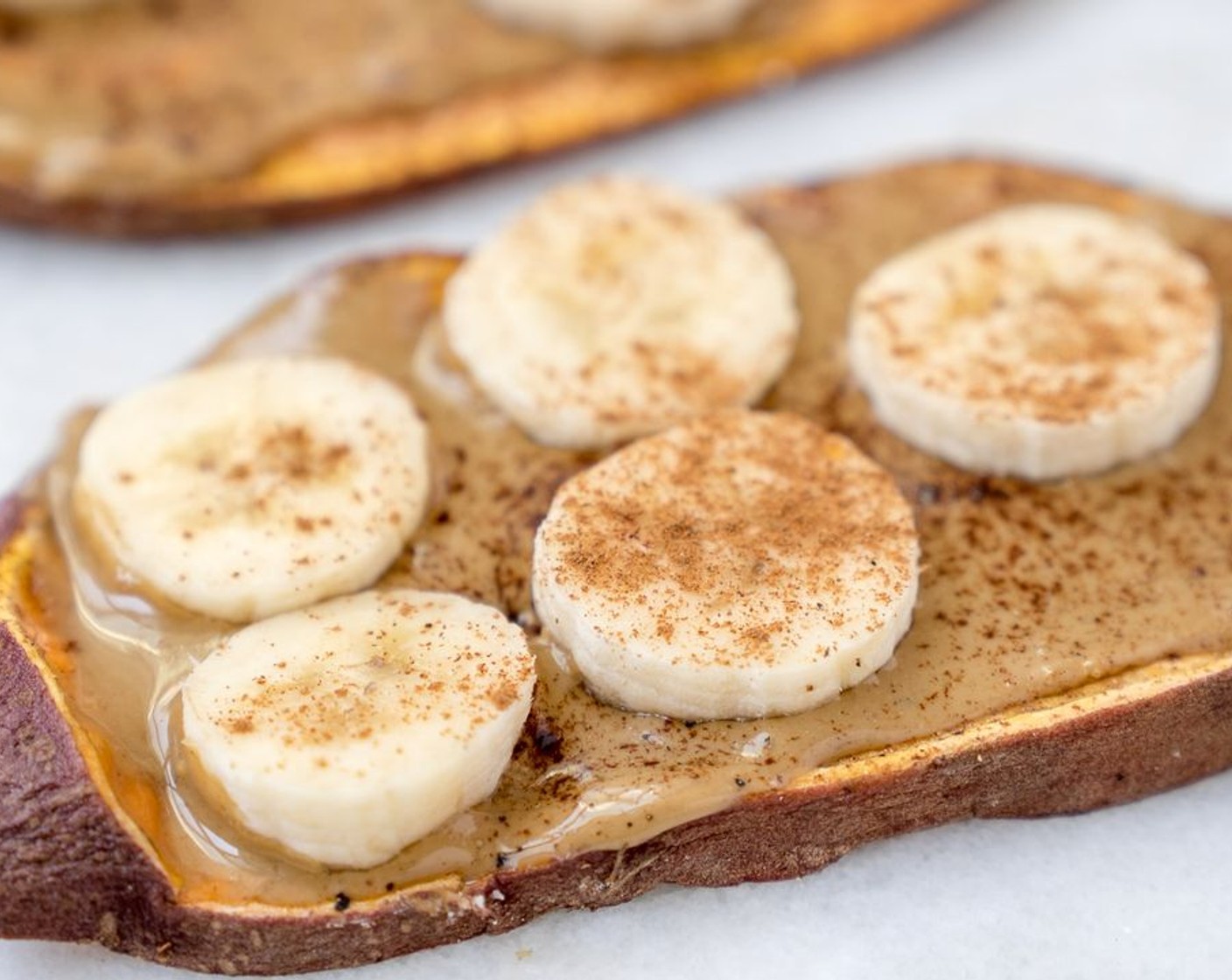 step 5 Slather 2 toasties with Sunflower Seed Butter (1/4 cup). Top with Banana (1/2) and sprinkle with Ground Cinnamon (1/2 tsp)