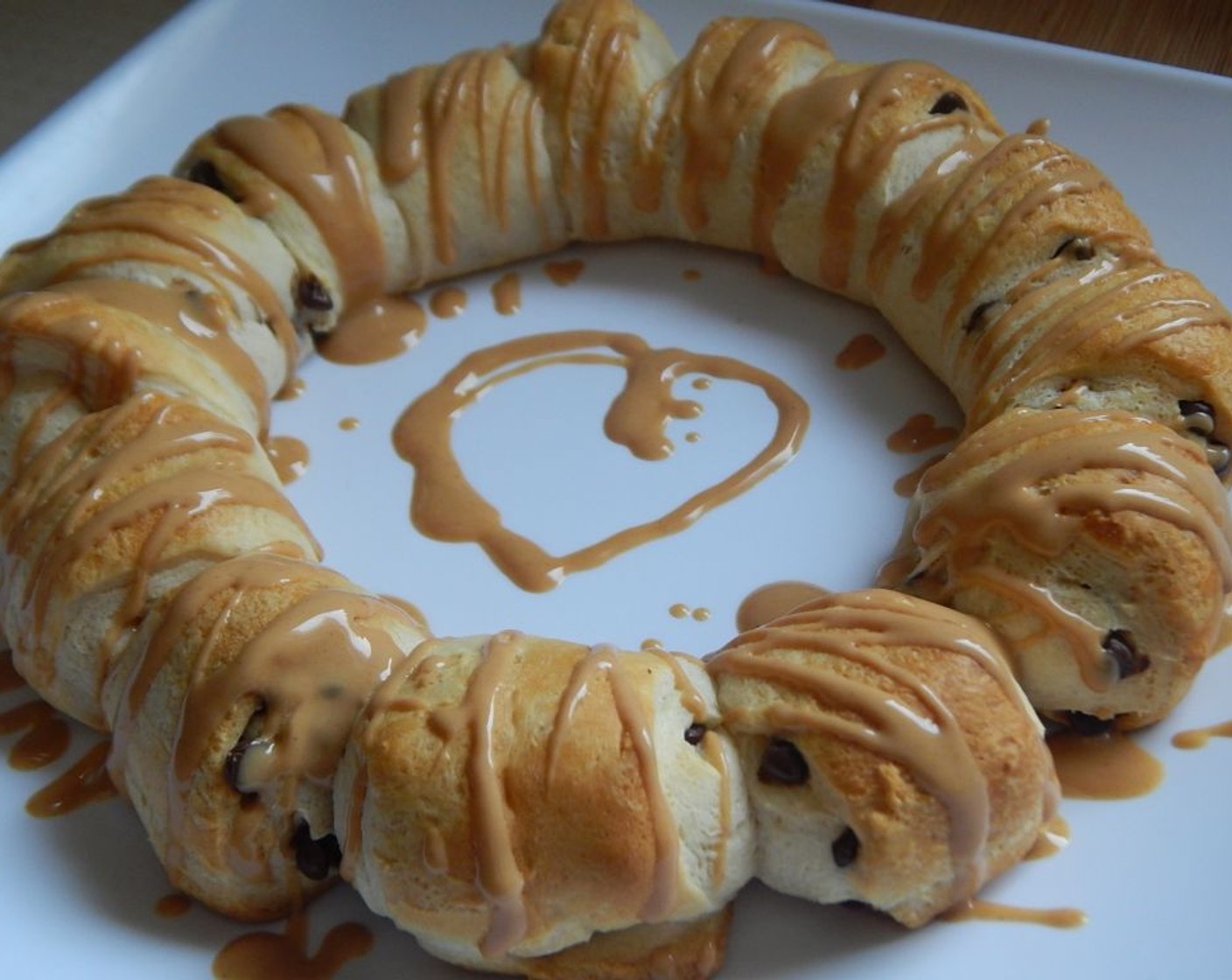step 8 Very carefully slide crescent ring onto a plate and drizzle with melted peanut butter. Best served warm.