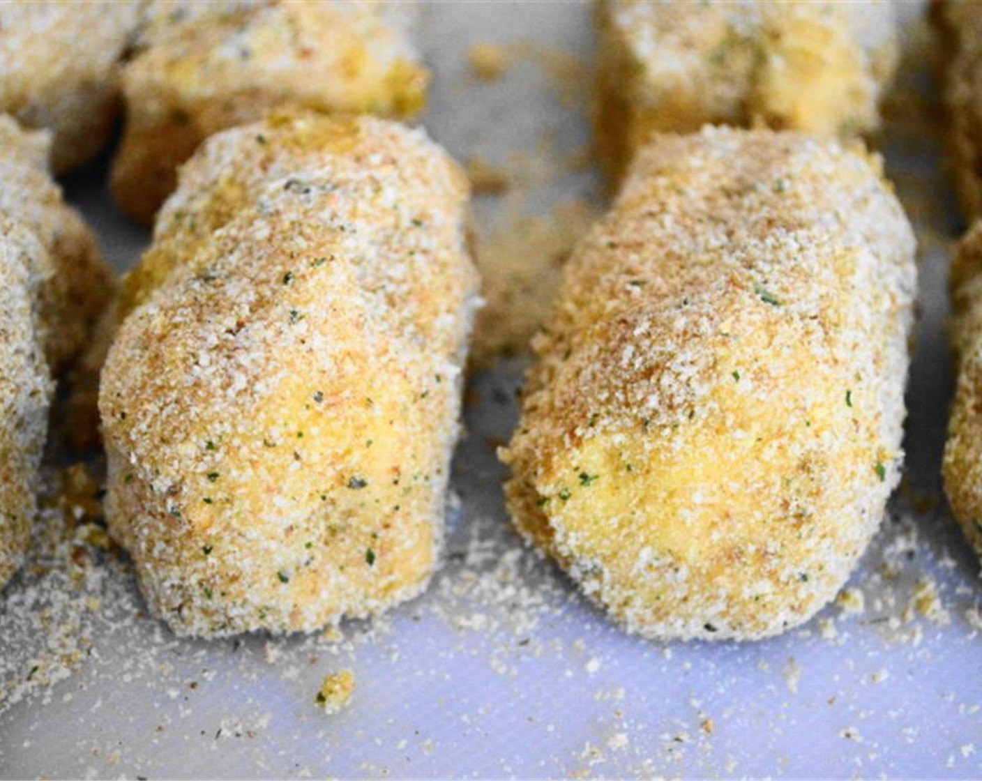step 2 Use a large ice cream scoop to scoop out uniform portions of the batter and form them into croquettes. Dip each croquette in Eggland's Best Classic Egg (1) then coat in Seasoned Breadcrumbs (1/2 cup).