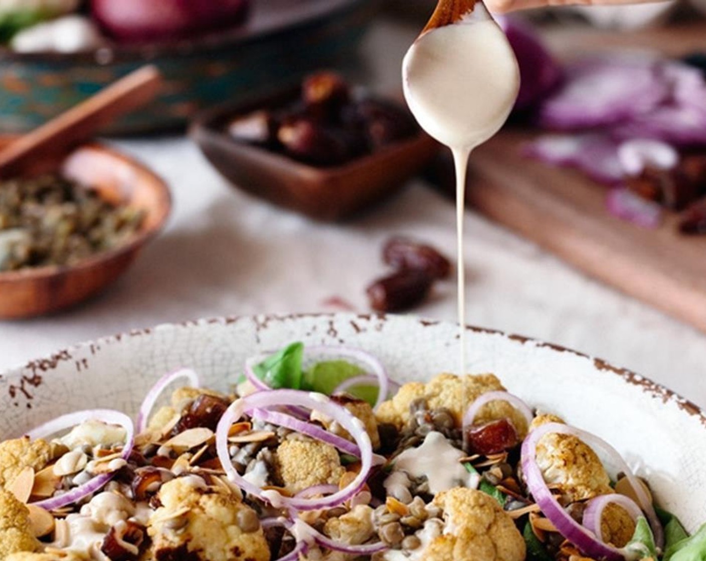 step 11 Drizzle it with the tahini dressing. Gently toss it while making sure that the dressing is distributed evenly within the salad.