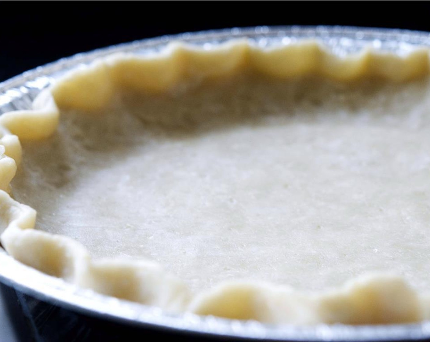 step 2 Transfer Pie Crust (1) to a pie pan. Trim off any excess around the edges.