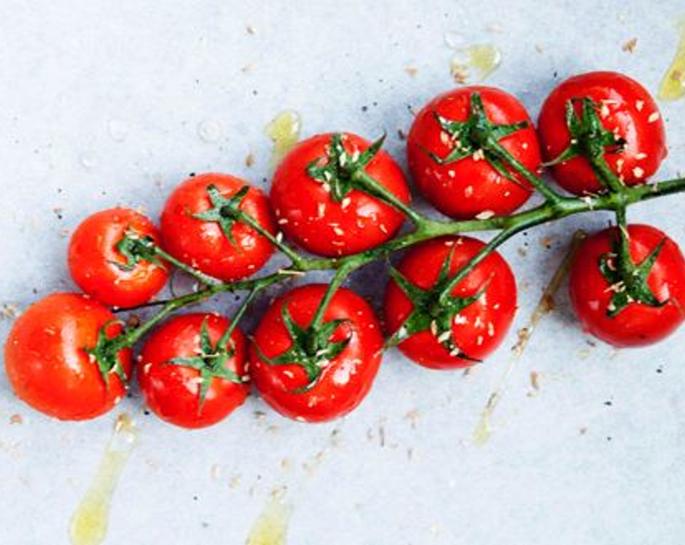 step 2 Lay Tomatoes on the Vine (2 1/2 cups) on a baking dish and drizzle with some Extra-Virgin Olive Oil (2 Tbsp) and season with Salt (to taste) and Ground Black Pepper (to taste).