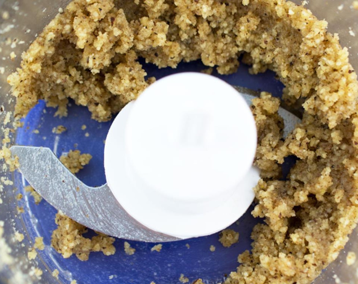 step 2 While pasta is cooking add chopped Walnut (3/4 cup) and Garlic (3 cloves) to a food processor. Pulse for 30 seconds. The texture will look similar to wet sand.