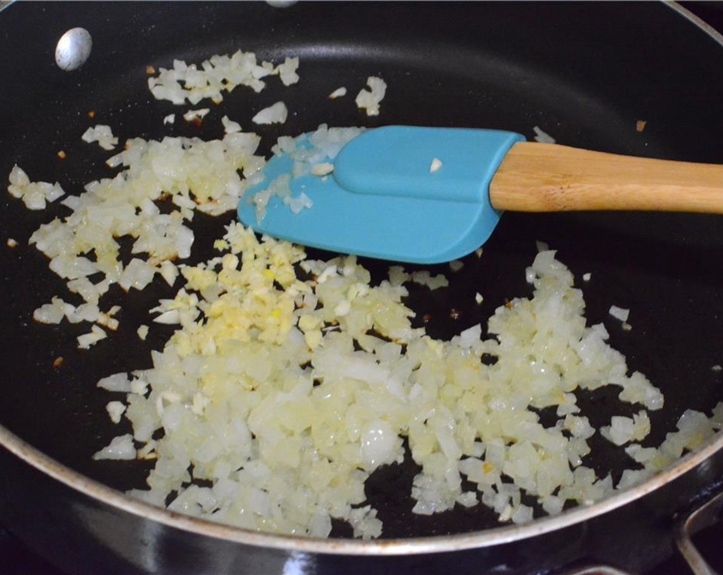 step 2 Heat Olive Oil (1 Tbsp) in a pan over medium heat and sauté the diced onion until it turns soft and translucent. Then add the minced garlic and sauté for another minute or so.