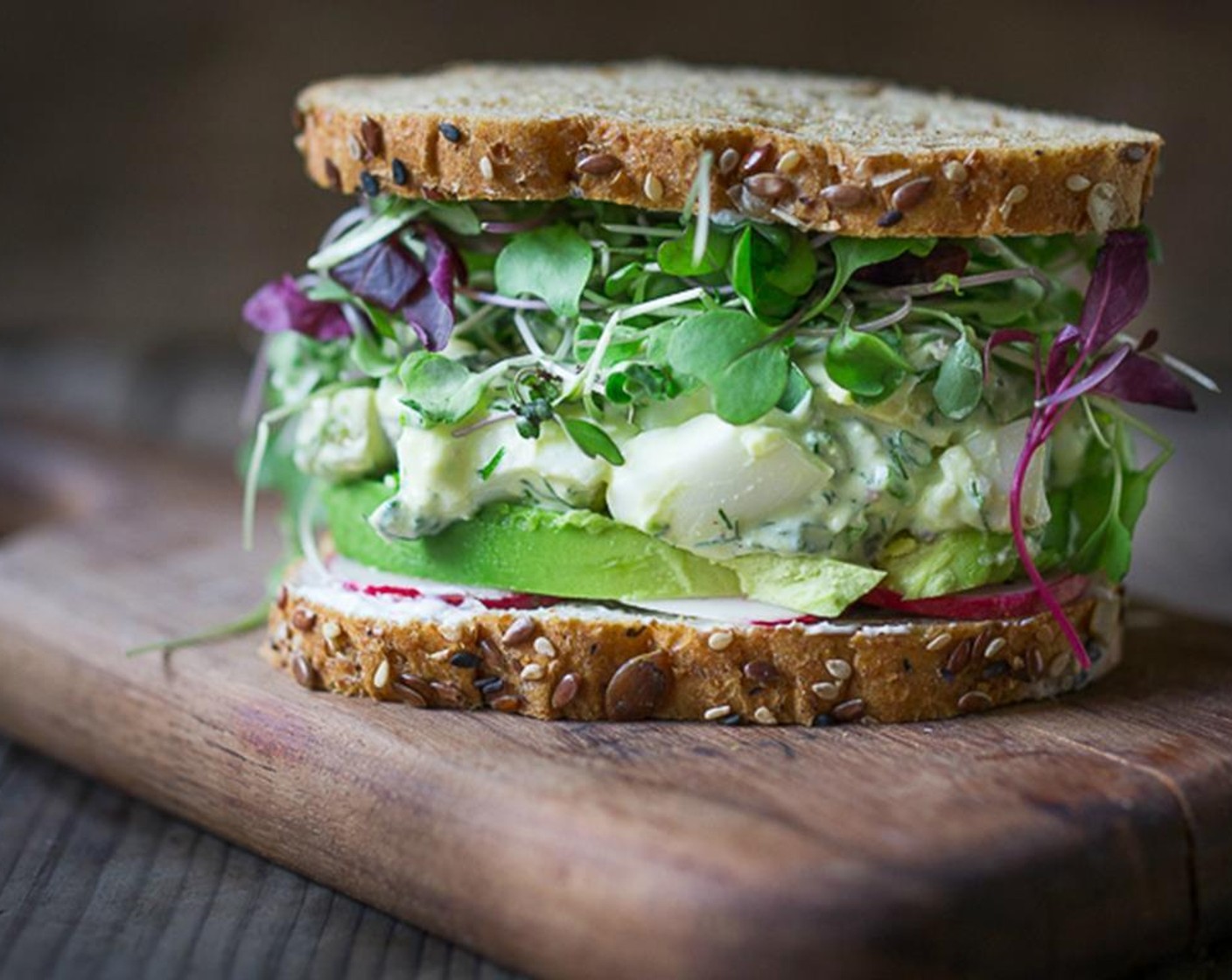 step 7 Top with a generous amount of egg salad, and a mound of micro greens. Either serve openfaced or top with second slice of Bread (8 slices). Cut in half diagonally. Enjoy!!