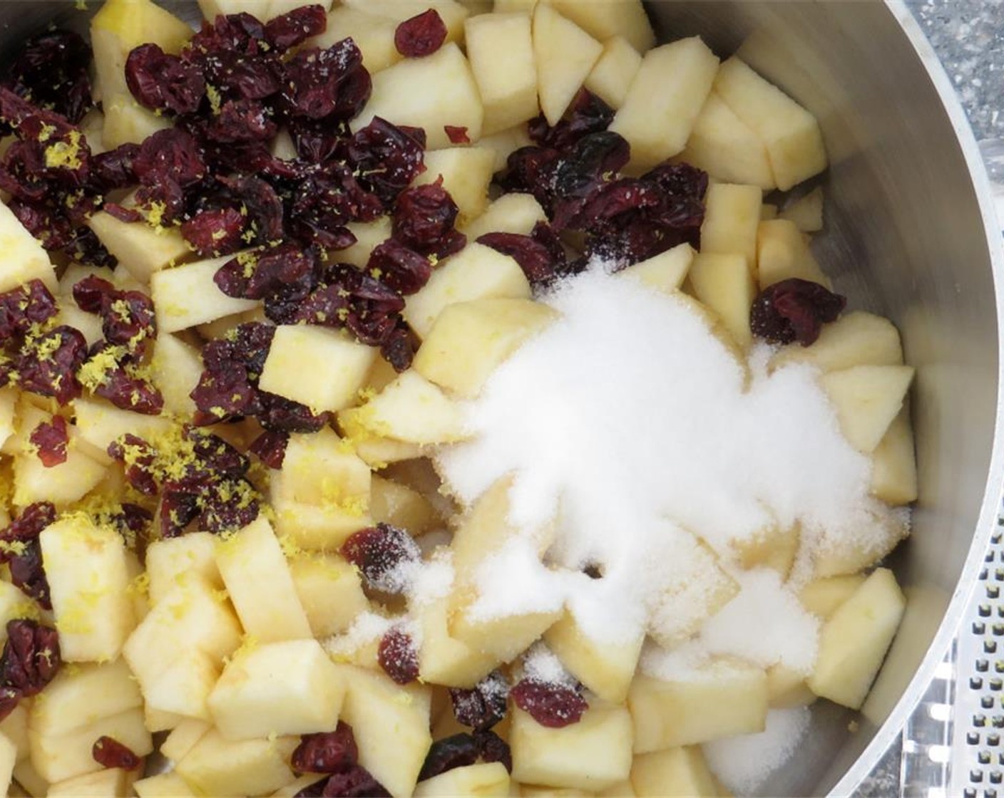 step 6 Heat a saucepan over medium heat. Add the diced apples, Dried Cranberries (1/2 cup), Granulated Sugar (1/4 cup), lemon juice and zest, and Water (1/2 cup). Cook until apples are softened and cranberries are plump 8-10 minutes.