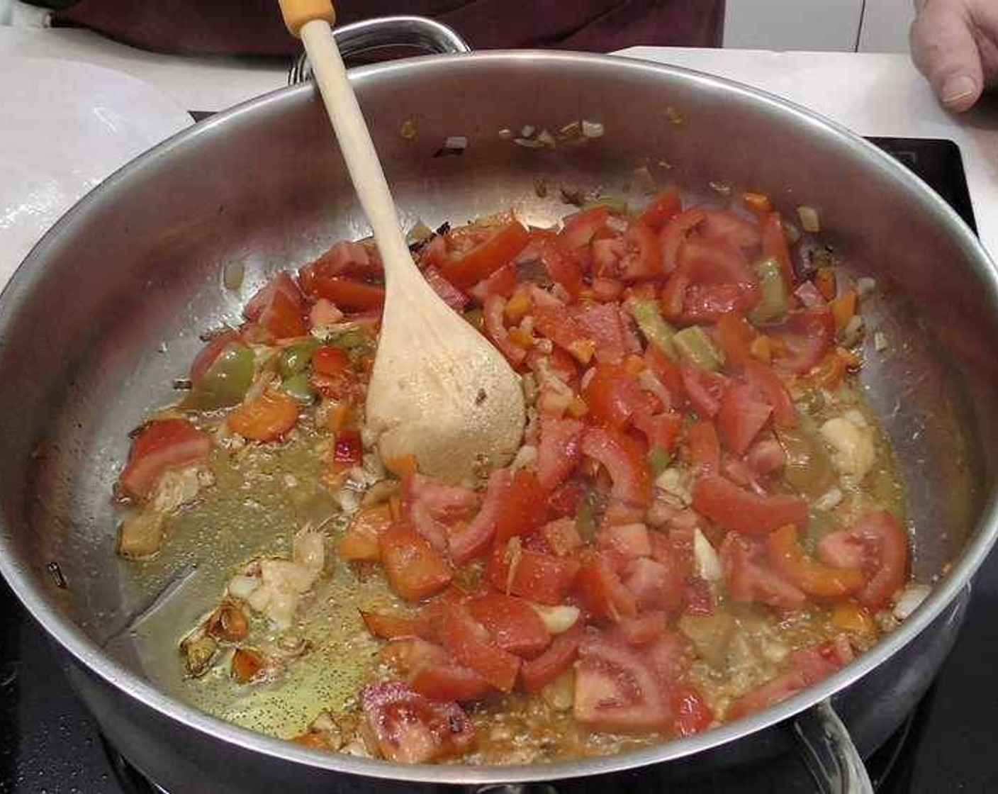 step 2 Once the peppers, carrots and onions are almost fully cooked, add in the Tomatoes (3) and a large cup of Water (to taste). Let it cook slowly for 10-15 minutes until all the vegetables are nice and soft.