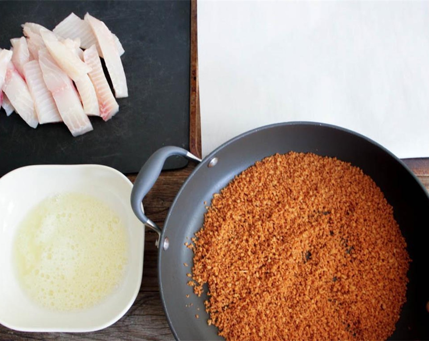 step 12 Create an assembly line for breading: fish, egg whites, seasoned breadcrumbs, and the prepared baking sheet.