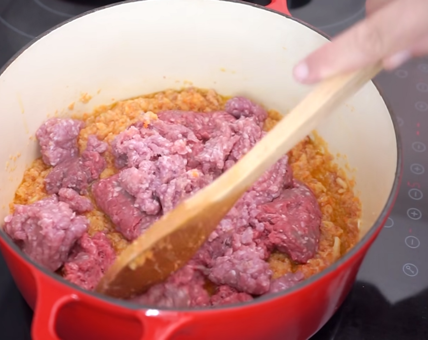 step 5 Add the Ground Beef (1.1 lb) and Ground Pork (7 oz) to your Bolognese sauce mix, breaking down the chunks of meat using a wooden spoon as you cook it.