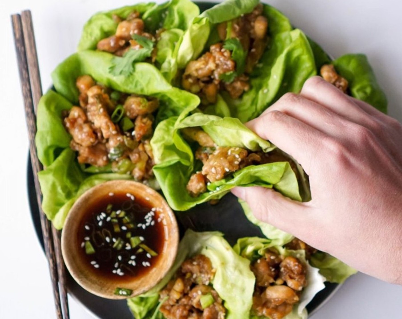 step 8 Serve the chicken inside the leaves of the Bibb Lettuce (1 head). Serve with a drizzle of Sriracha (to taste), or make a dipping sauce using 1/4 cup coconut aminos, 1 tablespoon honey, dash of sambal oelek, and sprinkle of sesame seeds.