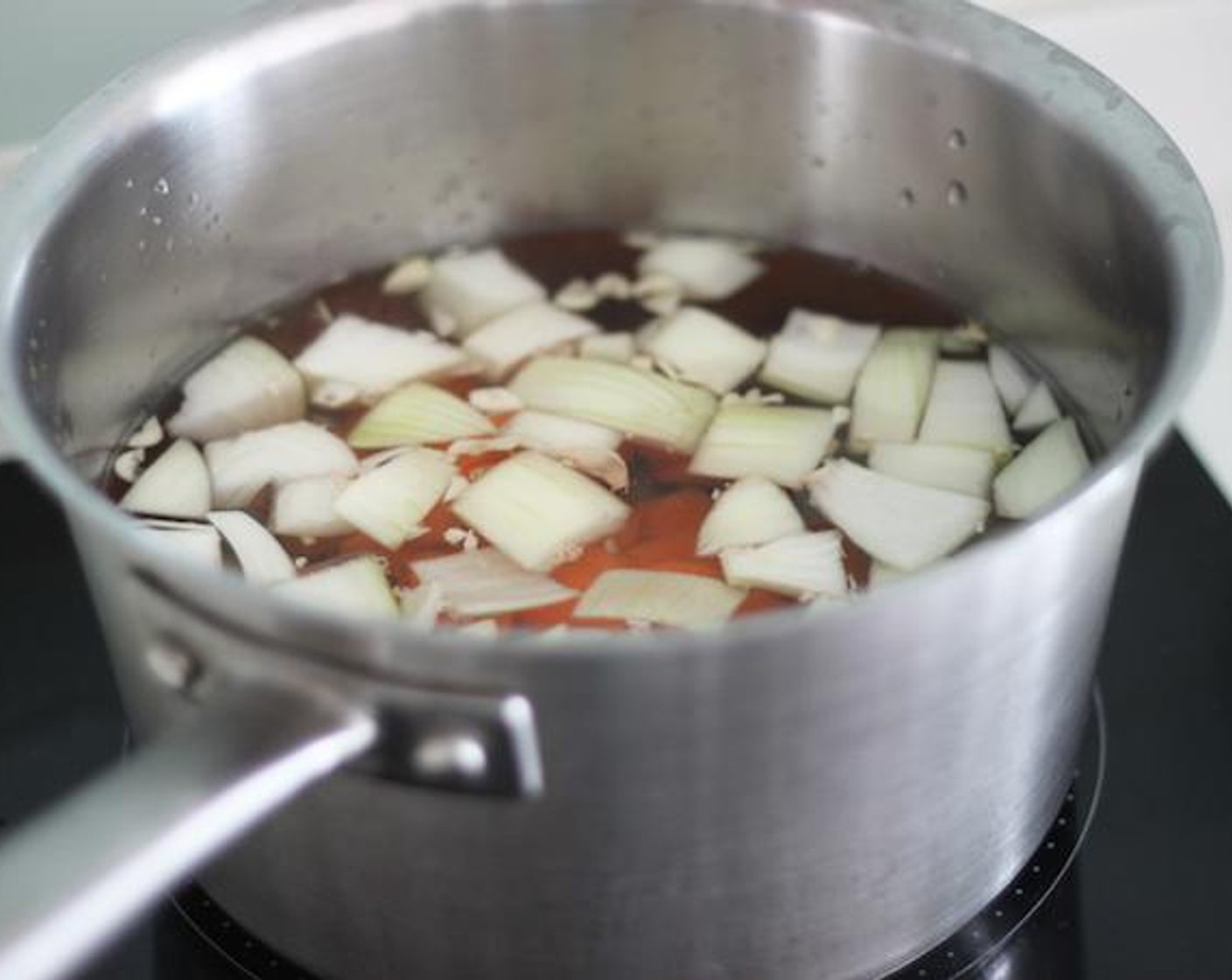 step 3 In a large pot, add Water (3 1/2 cups) and all veggies except for the mushrooms. Bring the mixture to a boil and reduce the heat to medium-low.