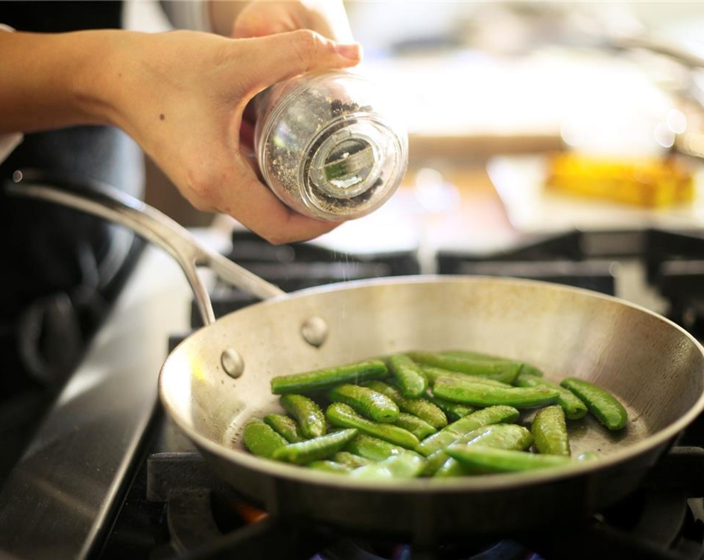 step 12 Wipe out the pan used for pineapple and heat the Sugar Snap Peas (1 cup) over medium high heat. Add Oil (1 tsp), Salt (1/4 tsp), and Ground Black Pepper (1/4 tsp).