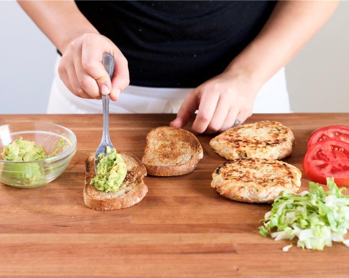 step 12 Meanwhile, in a second small bowl, use a fork to smash the Avocado (1/2). Add Salt (1/4 tsp) and Ground Black Pepper (1/4 tsp). Mix until well combined. Place the smashed avocado on one side of the toasted whole grain bread.