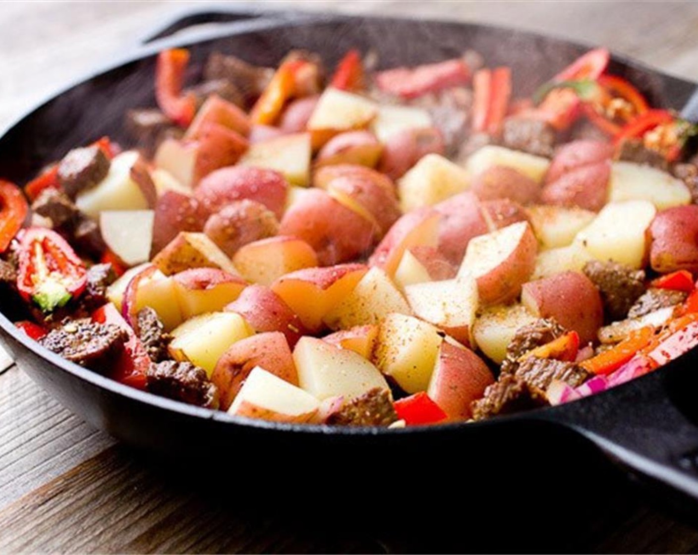 step 5 Scoot everything to outer parts of the skillet and  add the potatoes to the center. If the pan is dry, add a drizzle of Olive Oil (to taste) before you add the potatoes so they don't stick. Season with Salt (to taste) and Ground Black Pepper (to taste).