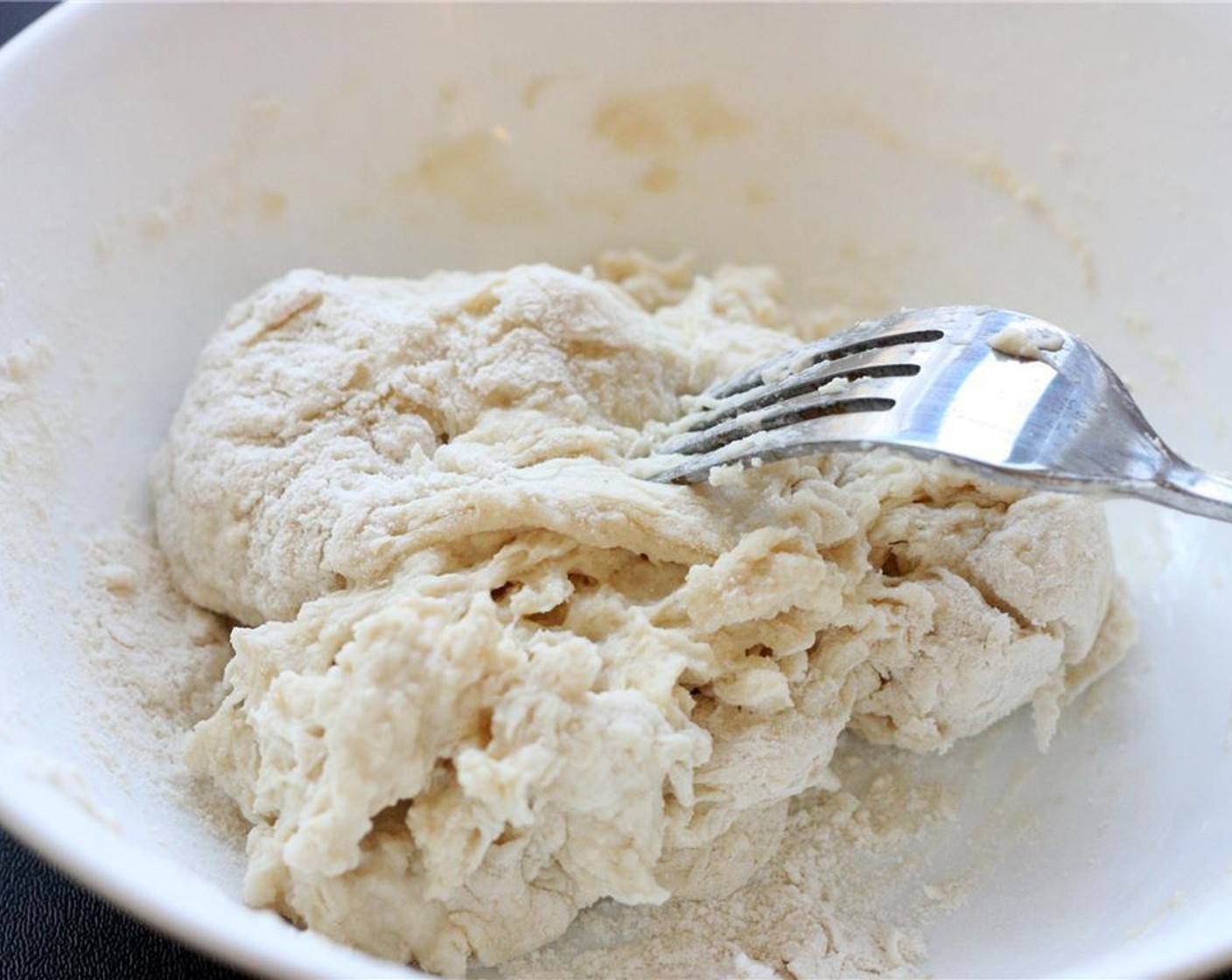 step 4 Add Water (1/2 cup) and mix with a fork until a dough is formed. It should be slightly sticky. You may have to abandon the fork and switch to using your hands before the dough is fully formed. Let rest for a few minutes.