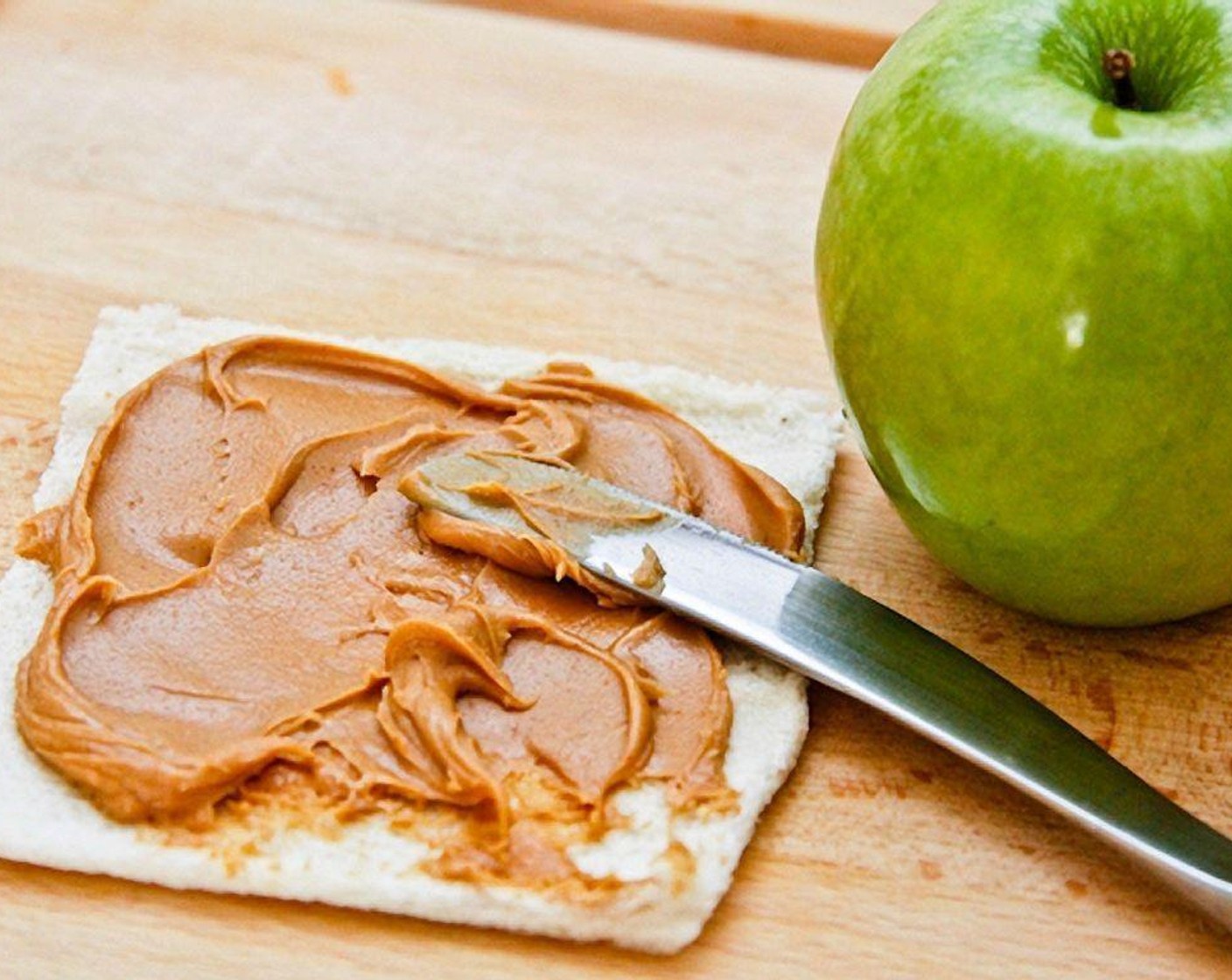step 7 For the third combination, use peanut butter and green apple. Spread the Peanut Butter (2 Tbsp) onto a slice of bread.