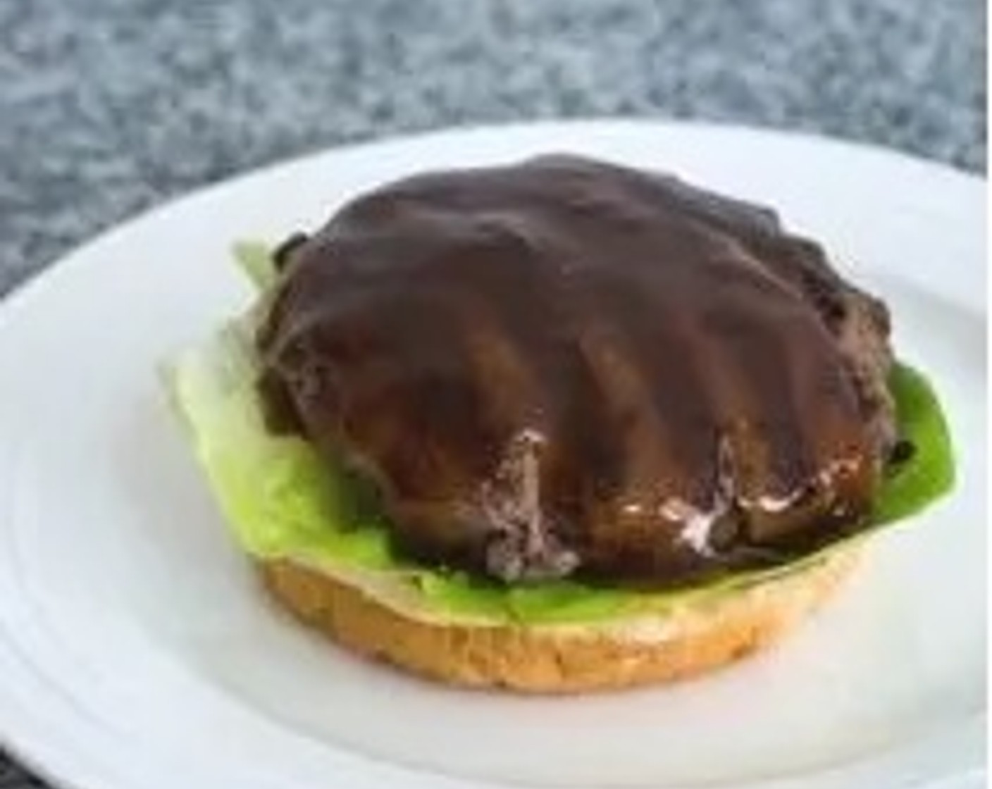 step 6 To assemble the Teriyaki Burgers, cut each Hamburger Buns (4) into two. Baste the top of each bottom burger bun with teriyaki sauce. Put Lettuce Leaves (as needed) on top of each bun together with the burger patties, and baste with more sauce.