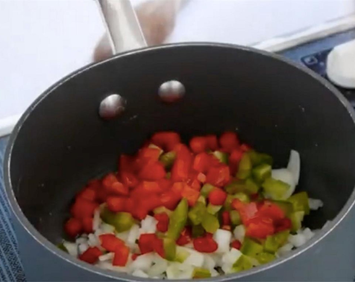 step 1 Dice the Onion (1/2), Garlic (2 cloves), Green Bell Pepper (1/4), and Red Chili Pepper (1/4). In a pan, sweat them for about 10 mins until soft.