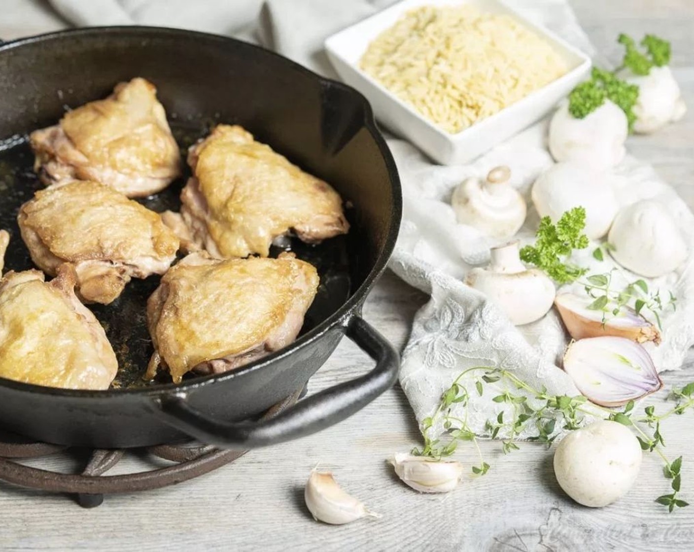 step 2 Heat Canola Oil (1 tsp) in a cast iron or oven-safe skillet over medium-high heat. Pat Chicken Thighs (6) dry with a paper towel. When the oil is hot, add chicken thighs and cook about 5-6 minutes on each side until skin is browned. Remove to a plate.