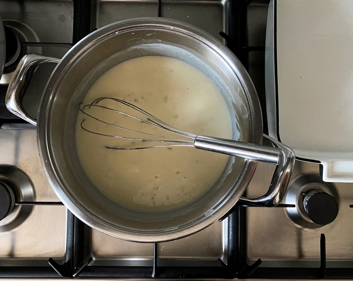 step 4 Pour in Milk (4 cups) and whisk over moderate heat until smooth, thickened, and starts to boil. Remove from the heat.