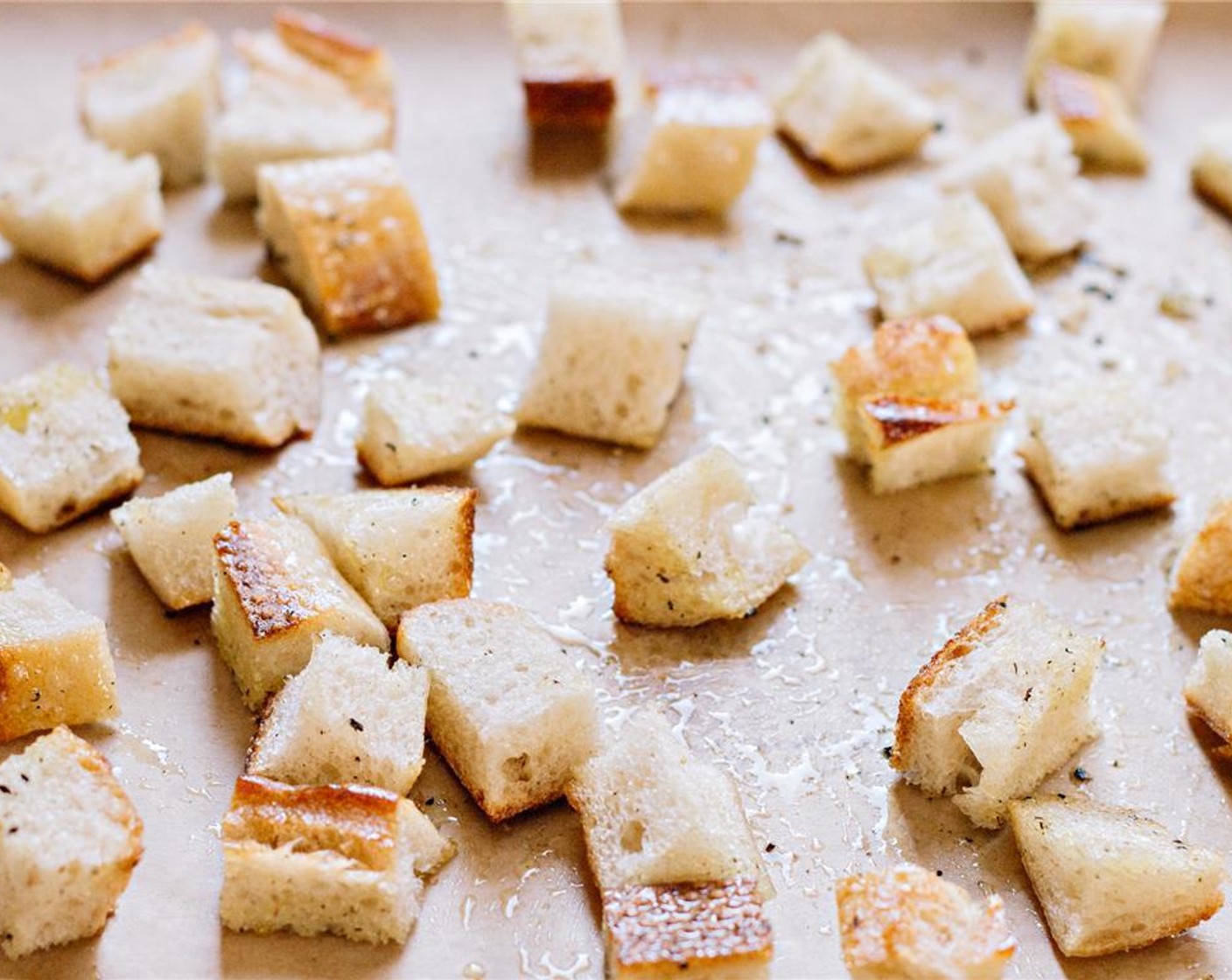 step 6 Toss the bread with Olive Oil (1 Tbsp) and a bit of salt and pepper to taste. Bake for 10 minutes, or until the croutons are crispy and golden.